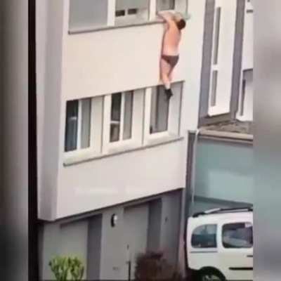 Trying to escape by hanging out from a window
