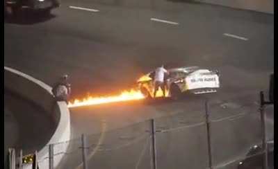 Dad rushes on the track to free his son from a burning racecar