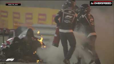 Grosjean helped out from the flames