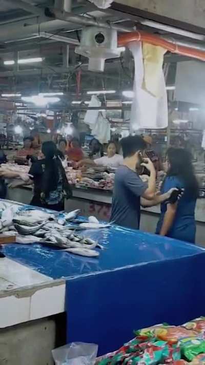 Philippines: Women hurl fish at each other during a wet market fight