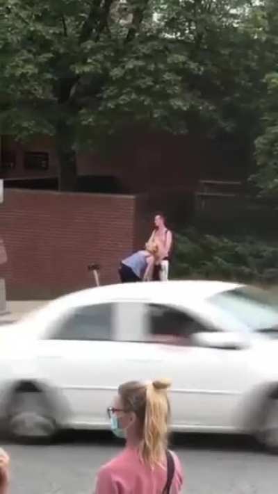 Guy getting a blowjob while yelling F the police in front of station.