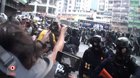 Social worker reads out legal rights for arrested protesters. HK police officer pepper-sprays her in the face to silence her.