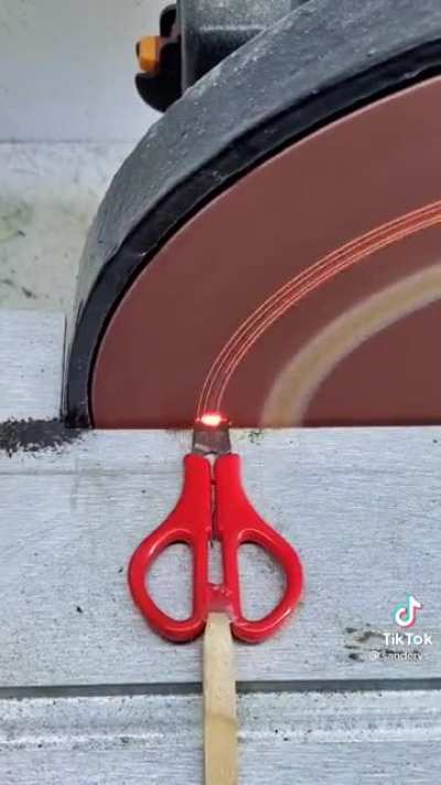 Pushing scissors through a sander