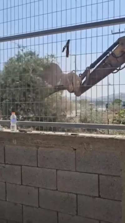 A Palestinian man, Khalil Alfari breaks down in tears as Israeli bulldozers uproot his trees before his eyes.