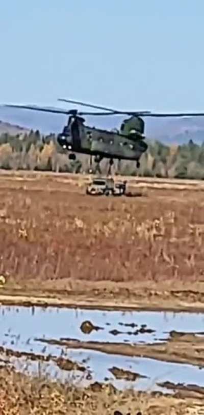 A chinook dropping a G-Wagon with a trailer.