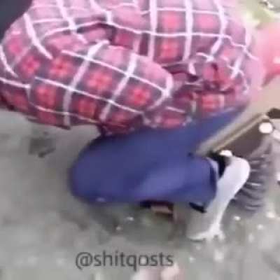 man swinging on a playground equipment and ends up getting his balls smashed by it