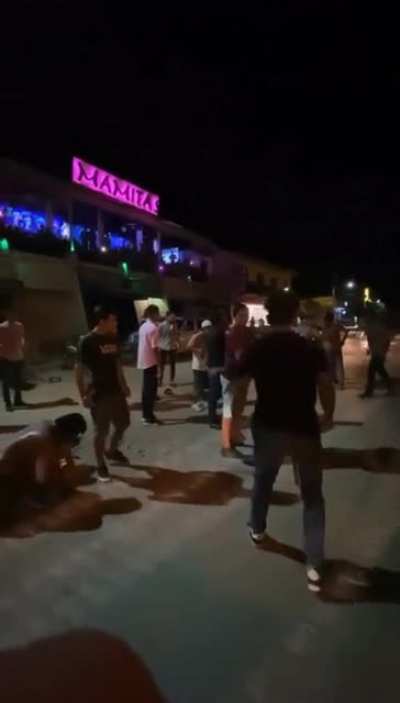 Latin America street fight with cumbia music & Spanish soccer announcer.