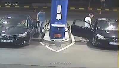 Guy standing next to gas pump refuses to put out his cigarette