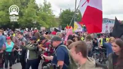 Mom tells her kids to stomp on pride flag in Ottawa.