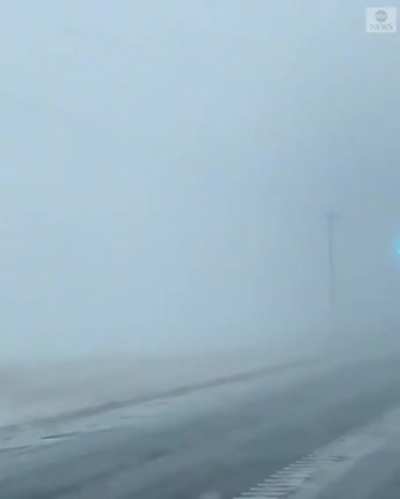 Power lines creating an arc in a blizzard