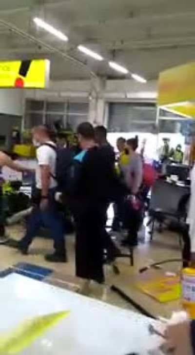 Aftermath of lootings during protests in Colombia, you can see both policemen and civilians kicking a thief who got caught.