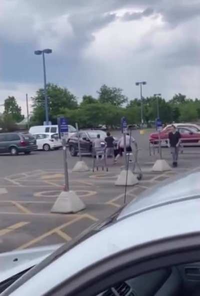 Dude punches a car and gets flung across a parking lot