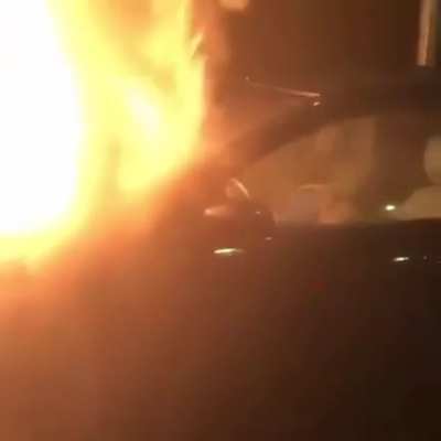 Guy sleeping in a car on fire