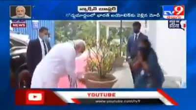 Respekt! Modi keeps nudging him till the guy touches his feet.