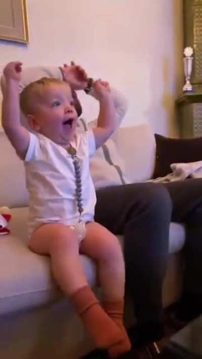 2-year-old Theo watching a game with his dad..