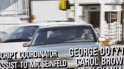 George Costanza driving magically has a poney tail