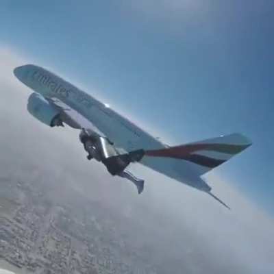 Jetman flying next to an Emirates A380 over Dubai