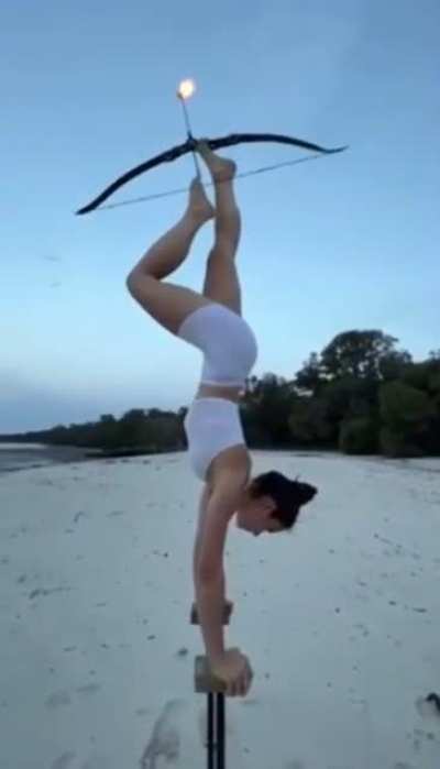 Woman hits bullseye using her feet.