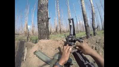 Colombian soldier defending his position using a machine gun survives an FPV drone attack. Kharkiv Oblast. Published on June 3, 2024.