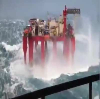 Offshore oil rig dealing with massive waves