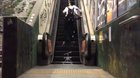 The graffiti on the escalator steps says 