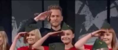 Realizing that it is a wrong place to do this salute