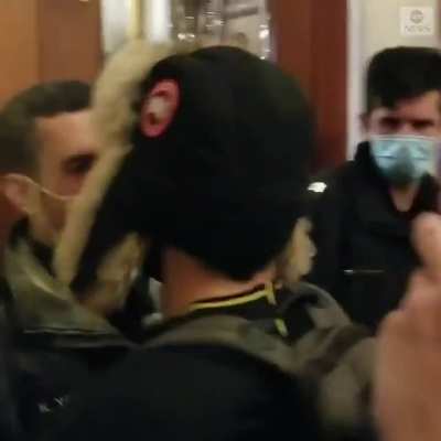 New video shows members of Congress inside the Capitol as a pro-Trump mob pushed against a barricaded door on Wednesday, with one rioter punching and breaking the glass