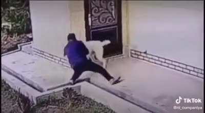 Guy holds down attacking dog until owner arrives.