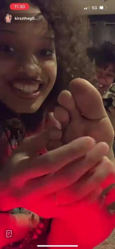 Playing with her friends feet