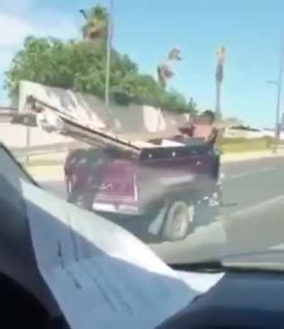 Fighting a cop attached to his vehicule and holding 2 ladders inside it...