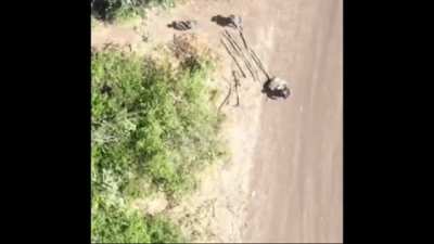 Ukrainian drone drops a grenade on a Russian soldier, wounding him, then as he receives help from comrades, a second grenade is dropped wounding several of them