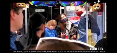 This german family gets yelled at because they have masks on. The crowd shouts: 