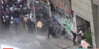 Riot cop charging alone at rioters