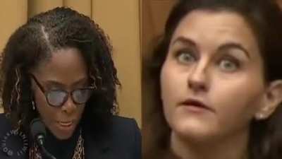 Who was the woman in blue behind Stacey Plaskett during her speech to Congress?