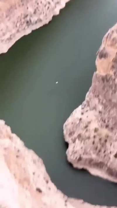 Throwing the rock really emphasizes how high up the cliff is