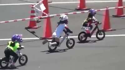 Cute bike race between tiny little girls