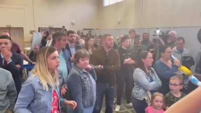General frustration in a Marine Le Pen supporter meetup. Two men on the right side of the video do not seem too disappointed with the results.