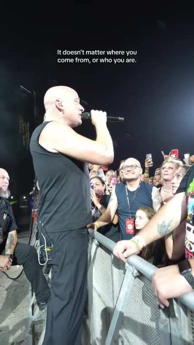 Lead Singer of Heavy Metal Band reassuring little girl at concert
