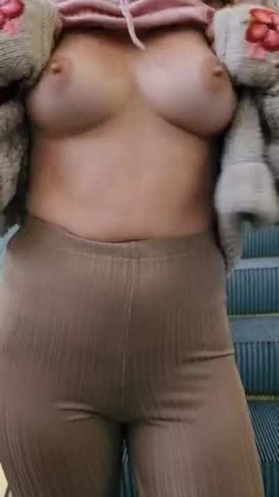 If you can't do an upskirt on the escalator, then a titty flash it is! [GIF]
