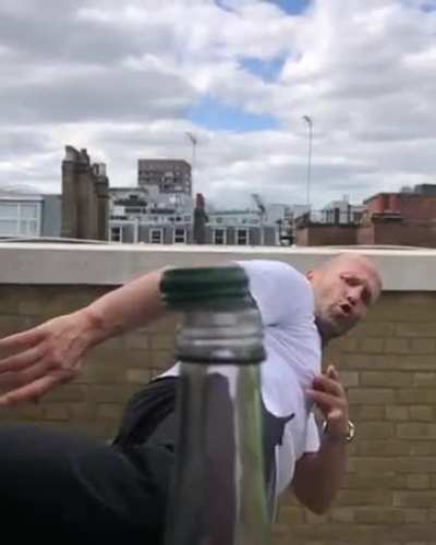 Jason Statham removing bottle cap with kick