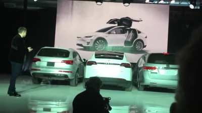 Elon Musk demonstrating how the Model X Falcon wing doors would open in a tight parking spot