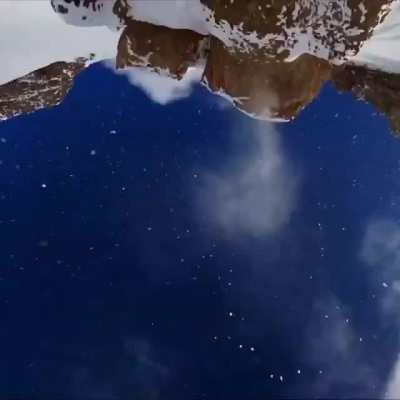 He jumps off a hecka tall mountain