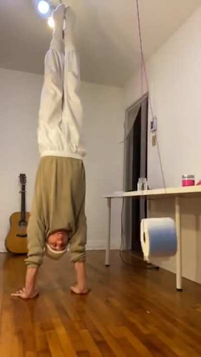 Shooting a ping pong ball through a spinning toilet roll using your mouth while doing a handstand