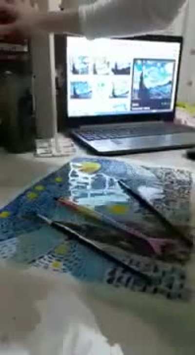 Girl accidently spills water over her painting