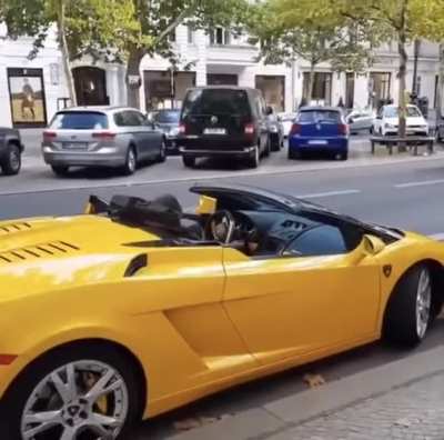 Homeless man laughs at car