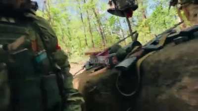 Russian marines take cover in a trench as artillery lands nearby