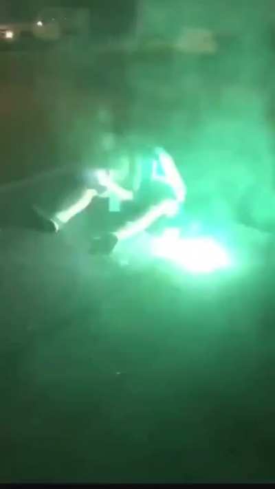 This young man having a seizure and trying to let people shooting fireworks at him know