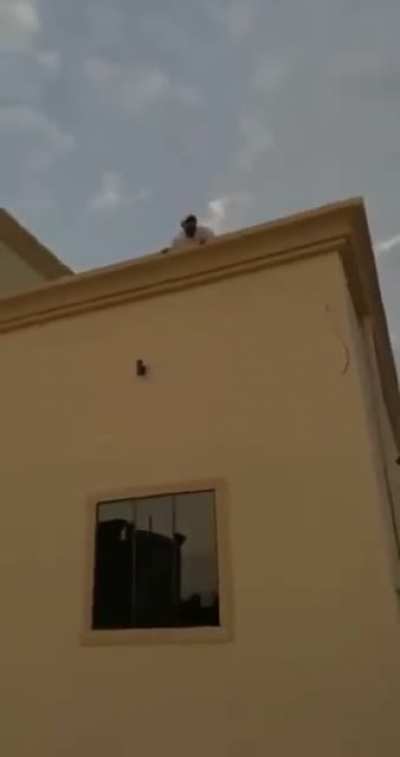 Some Arab blokes messing around with their friend