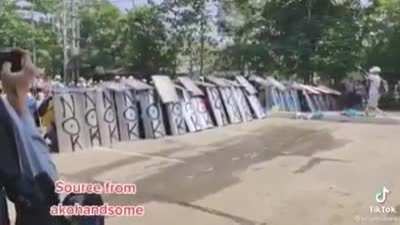 Myanmar anti-coup protestors practicing shield formations.