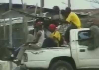 A technical packed with combatants is hit by sustained gunfire Liberia, Africa